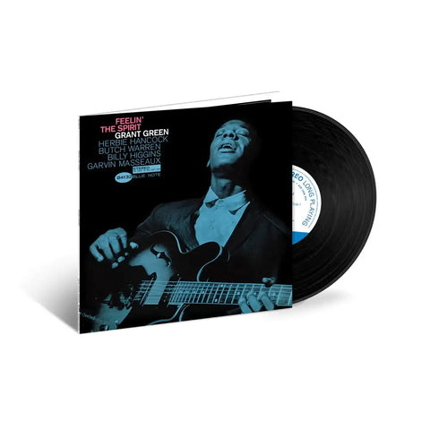 record cover shows grant green playing the guitar. vinyl record sticking halfway out