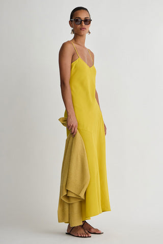 Woman wearing a yellow dress on a white background