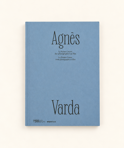 Agnès Varda: La Pointe Courte, From Photographs to Film photography book with blue cover and black typography, photographed against a warm cream background.