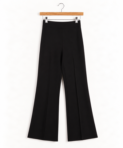A pair of high-waisted black wide-leg trousers hanging on a wooden hanger against a clean white background.