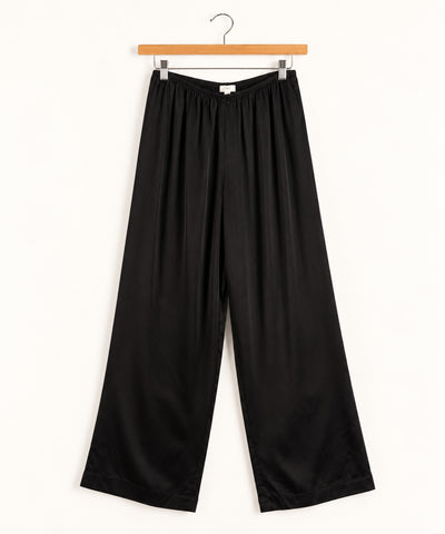 black silk wide leg pant on wooden hanger against white background