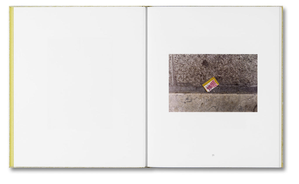 Open book with a photograph of a street scene on one page