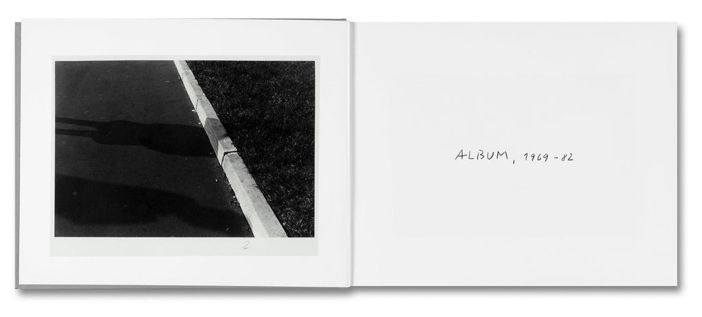 Open book with a black and white photograph of a curb and grassy field, titled 'Album 1989-92'.