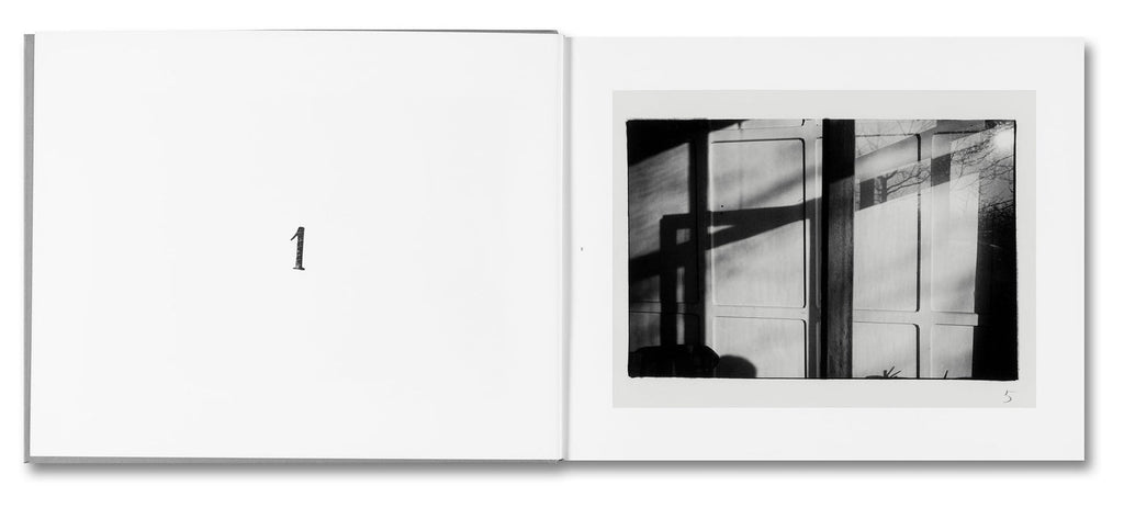 Open book with a black and white photograph of a building facade on a white background