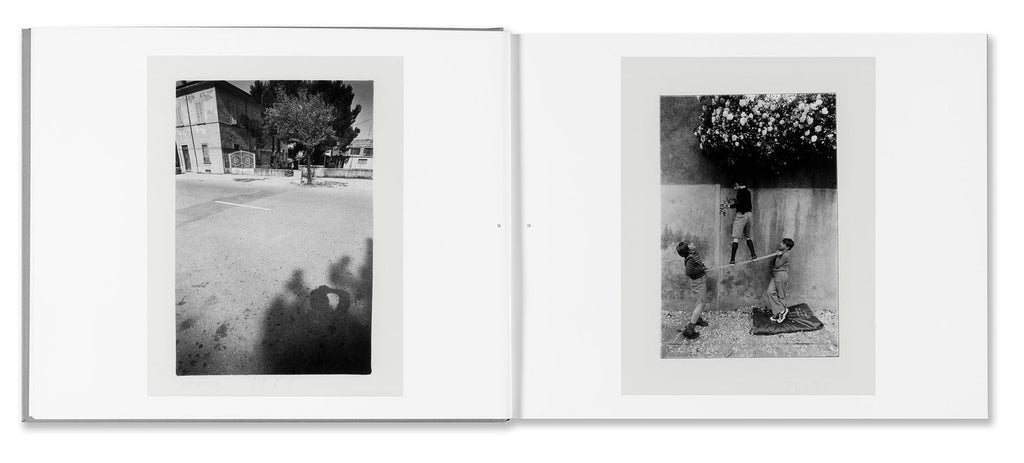 Black and white photo album open to two pages showing outdoor scenes with people.