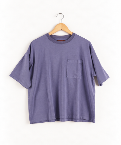 lavender t shirt with one chest pocket on wooden hanger against white wall