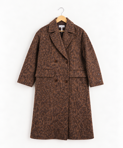 A brown and black leopard print double-breasted coat on hanger against white wall