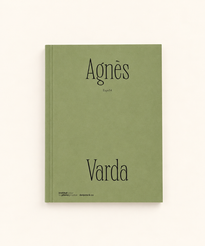 Agnes Varda Expo54 photography book with sage green cover and black typography, photographed against a warm cream background