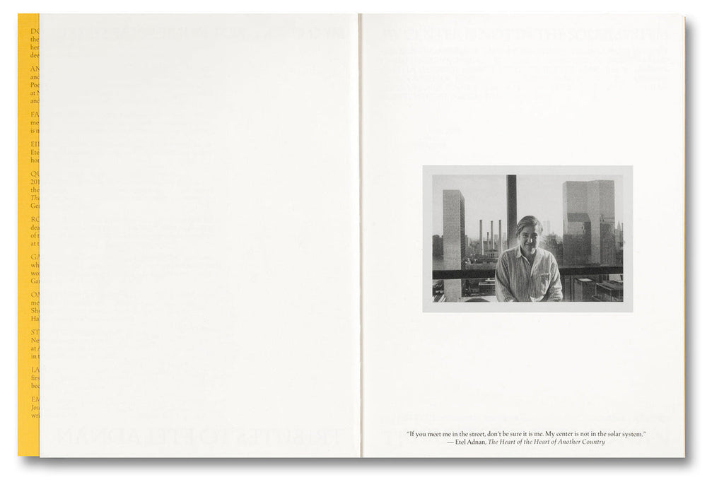 Open book with a black and white photo of a person in a room with large windows, yellow ruler on the left side.