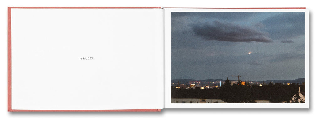 Open book with a photograph of a cityscape at dusk on the right page.