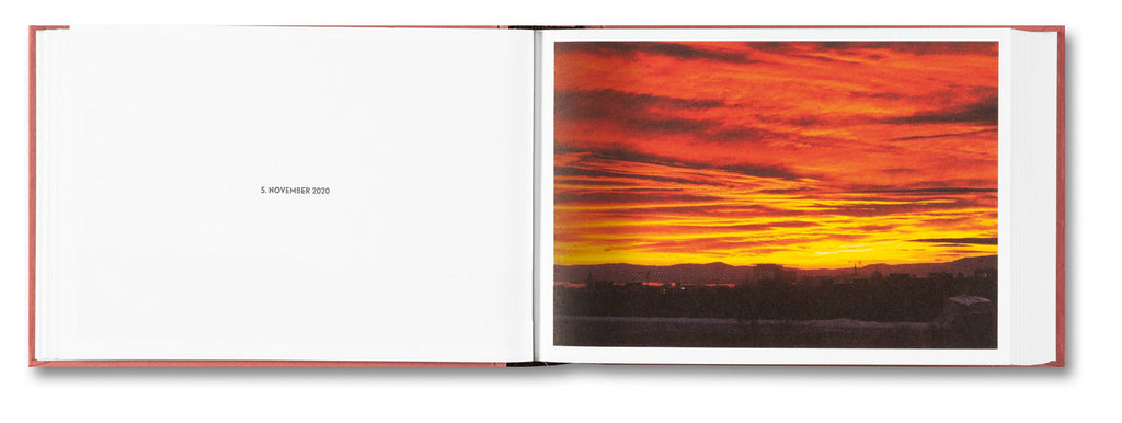 Open book showing a vibrant sunset landscape