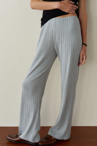 Front close-up view of a model from the waist down wearing light heather gray, ultra-fine ribbed knit wide-leg pants