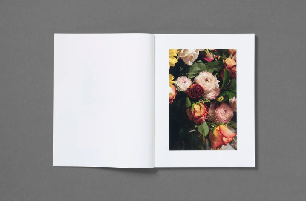 Open book with a floral illustration on a gray background