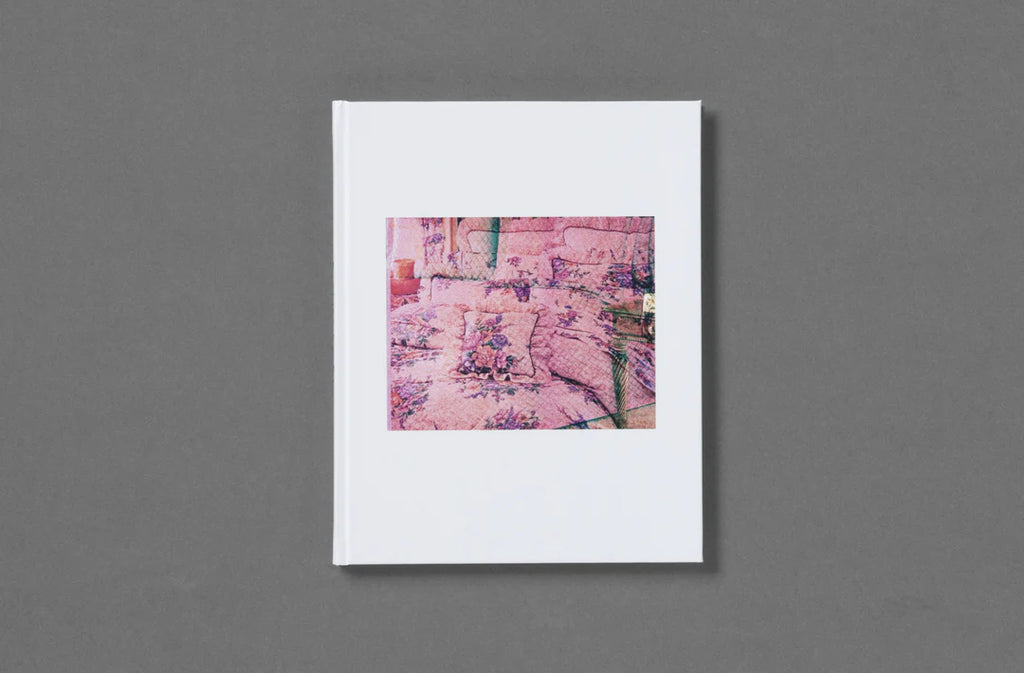 White book with a colorful illustration on a gray background