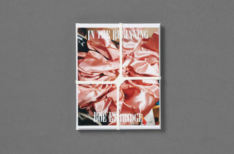 Book titled 'In the Beginning' with a cover featuring fabric textures on a gray background