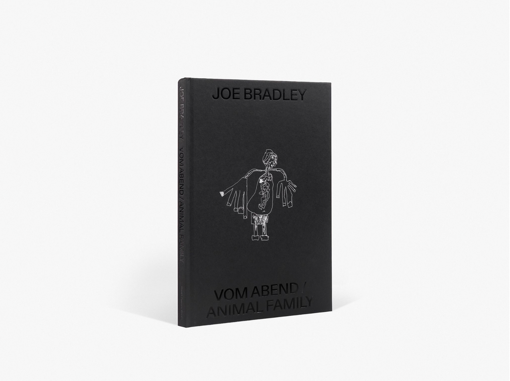 A black rectangular book cover or exhibition catalogue titled "JOE BRADLEY" in black capital letters at the top, and "VOM ABEND / ANIMAL FAMILY" in black capital letters at the bottom, displayed vertically against a plain white background. White line drawing on center of book.
