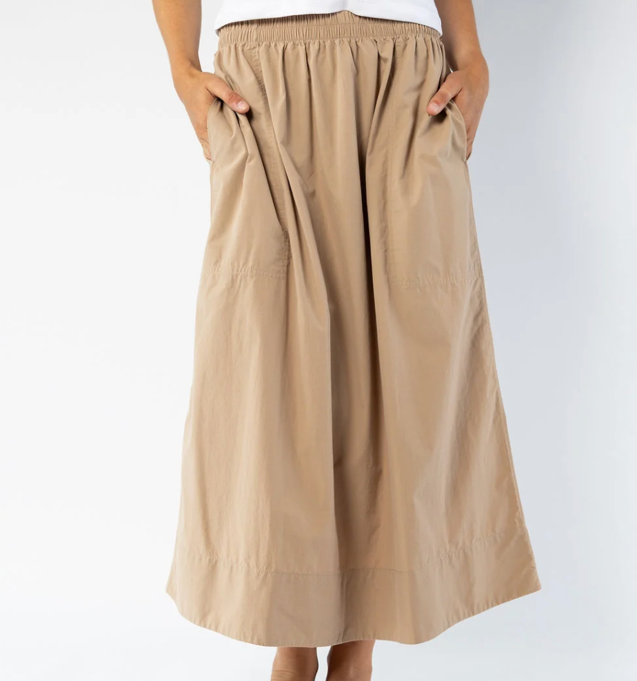 A beige wide-leg midi skirt with an elastic waistband and side pockets, shown on a model against a light gray background.