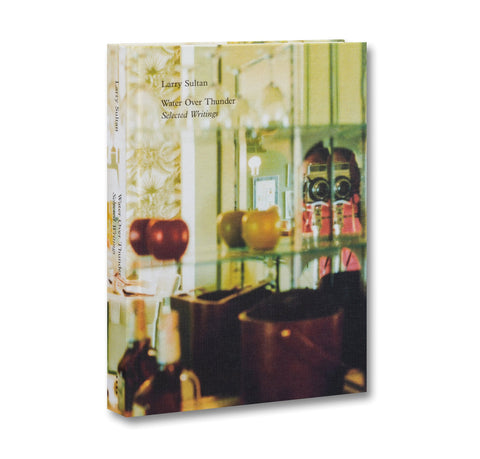 Book cover with a photograph of a room and text 'Larry Sultan Water Over Thunder Selected Works'.