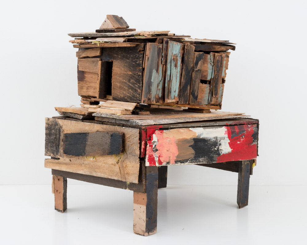 A weathered wooden sculpture on white background