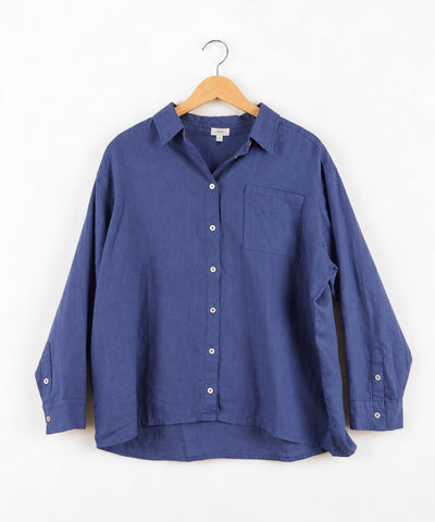 A blue long-sleeve button-up shirt with a pointed collar, white buttons, and a single chest pocket, shown on a hanger against a plain white background.
