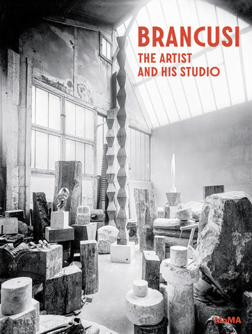 Book cover titled "BRANCUSI: THE ARTIST AND HIS STUDIO" by MoMA, featuring a black-and-white photograph of sculptor Constantin Brâncuși’s cluttered art studio filled with raw stone blocks, wood logs, and towering geometric sculptures under a large, bright skylight.