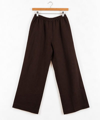 brown wide leg pant on wooden hanger against white background
