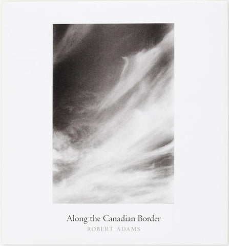 Book cover of 'Along the Canadian Border' by Robert Adams with a black and white abstract design.
