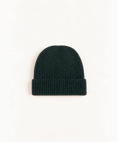green wool beanie on white background