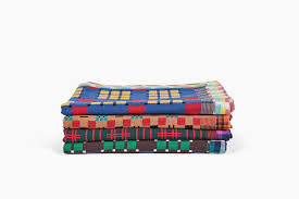 stack of colorful blankets on white background
