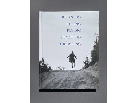 cover of book with image of person seeming to float above the ground on top of hill Black and white image. Running falling flying floating crawling written across the sky